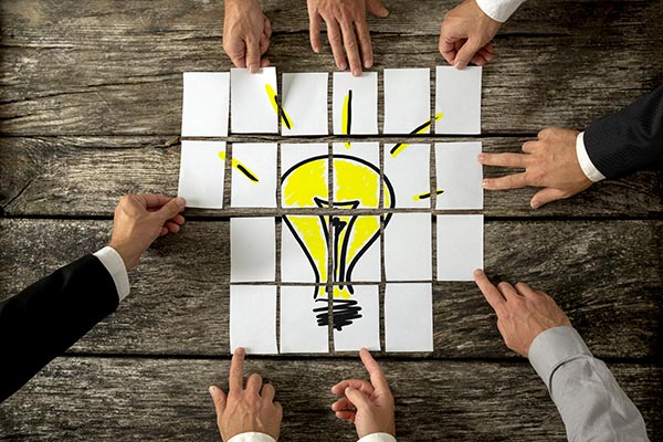 Lightbulb drawn on cards and placed together like a puzzel