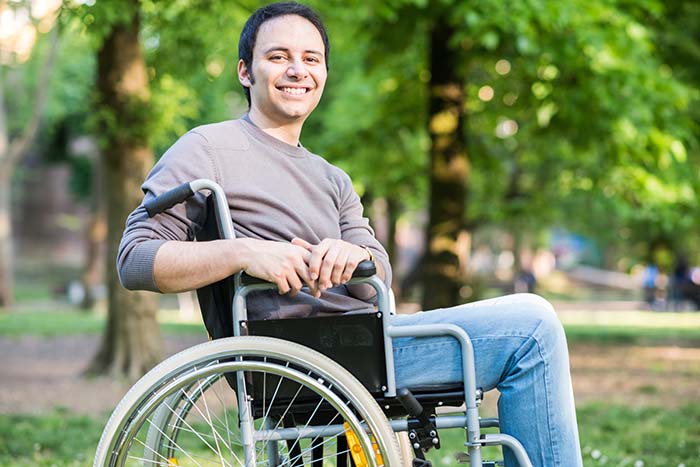 Young man in a wheel chair smiling
