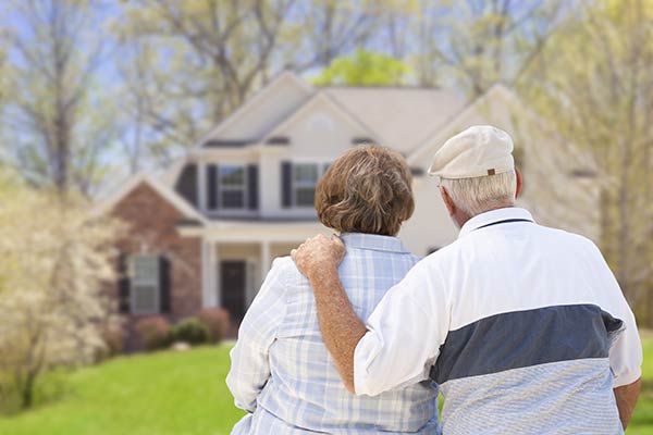 Old couple looking at their home